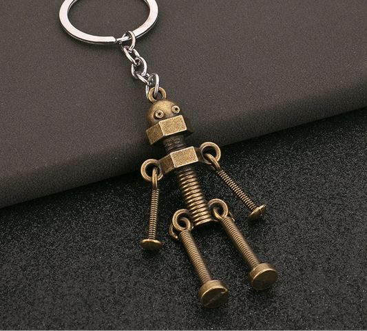Keychain shaped like a robot made of screws on a dark background