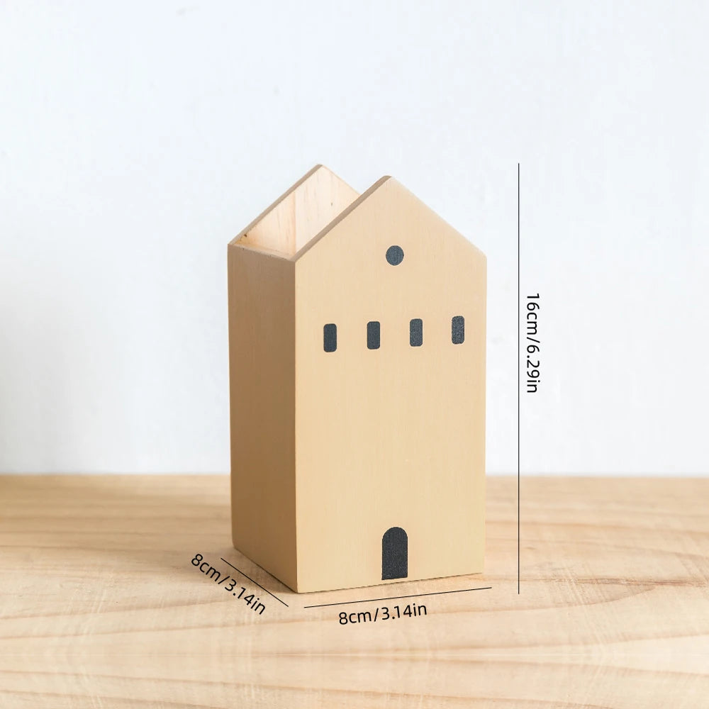 Wooden house-shaped object with dimensions on a wooden surface