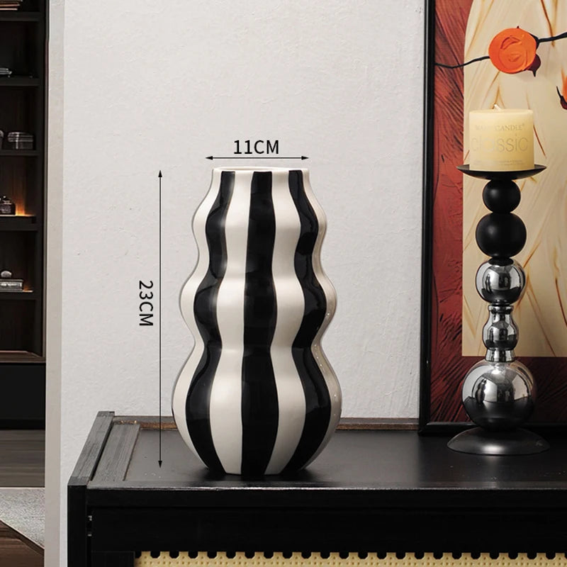 Black and white striped vase on a table with dimensions displayed