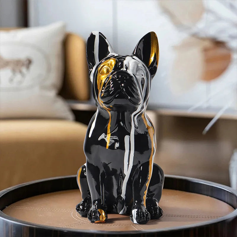 Modern French Bulldog resin sculpture featuring a glossy black, white, and gold finish displayed as a contemporary home décor ornament.