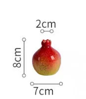 Measurement chart of a red and yellow ceramic pomegranate with dimensions labeled.