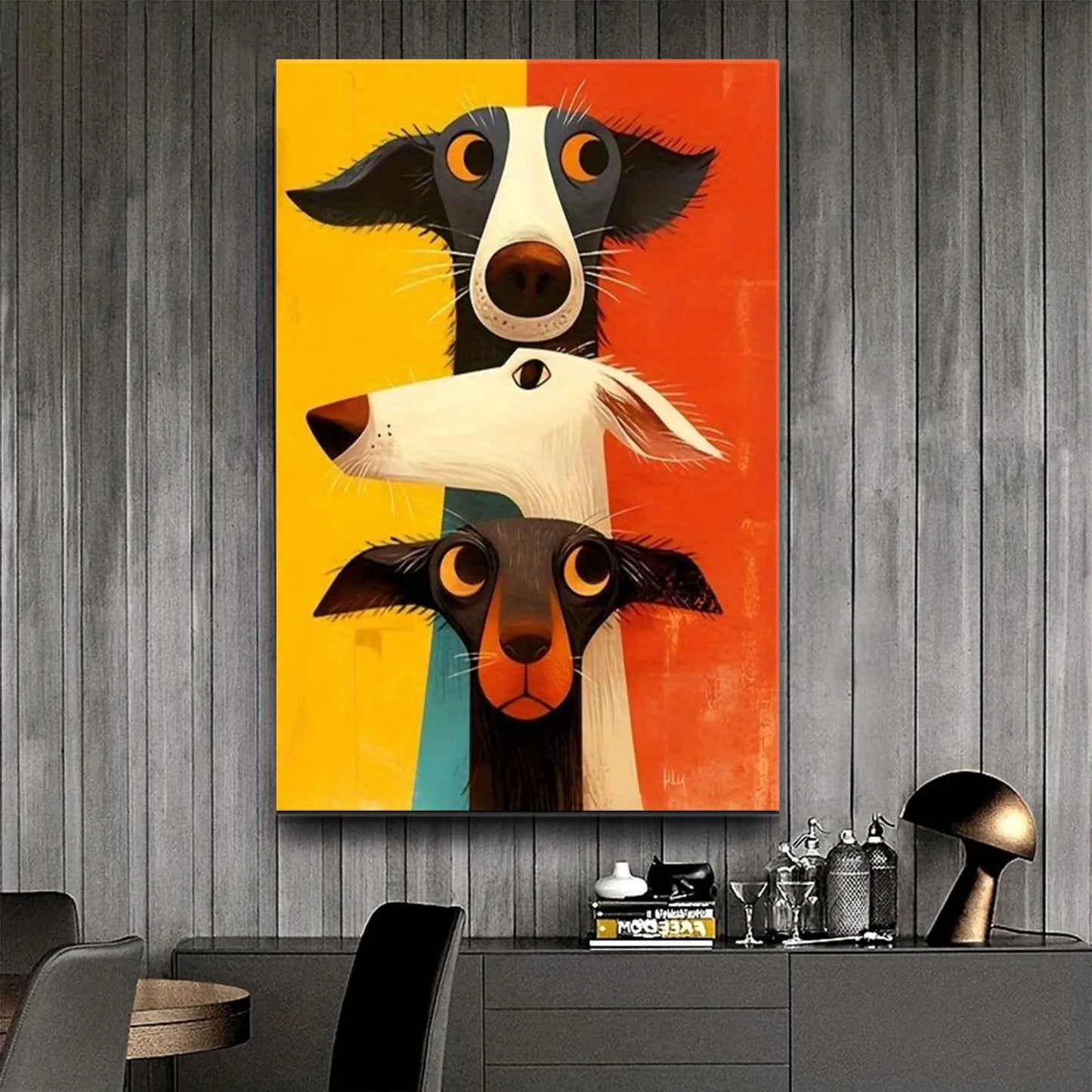 Abstract painting of three dogs on a yellow, orange, and blue background, hanging on a wooden wall.
