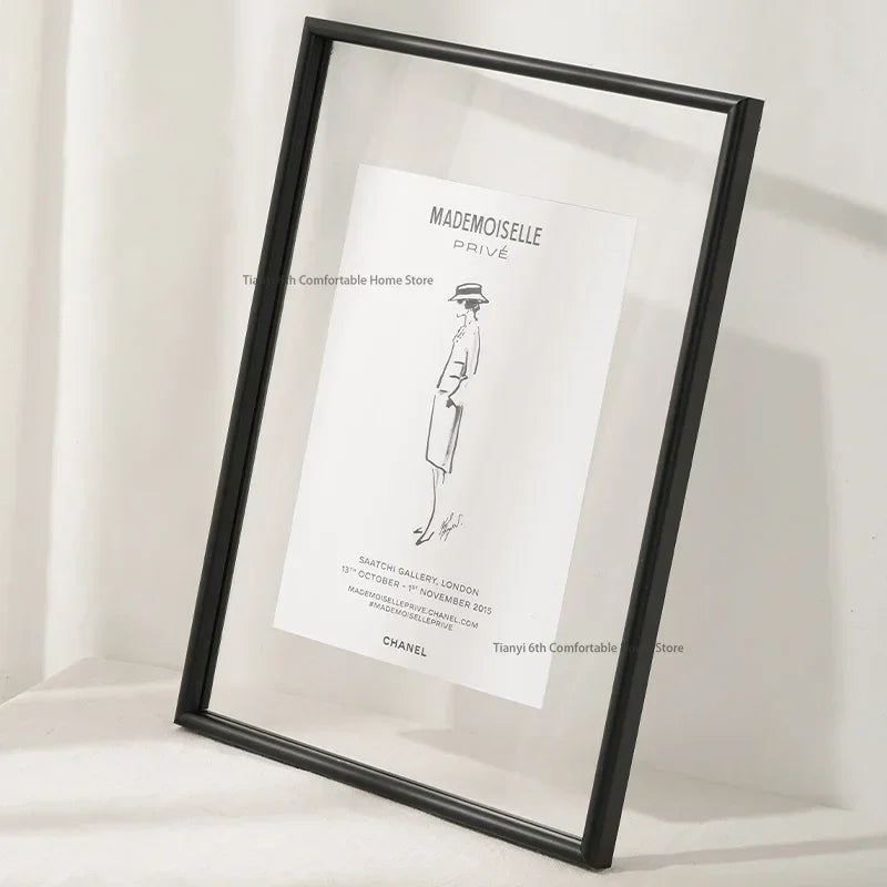 Framed black and white poster of a woman in a dress on a white background