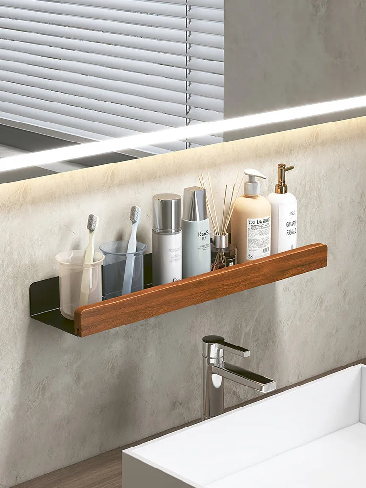 Bathroom shelf with toiletries against a mirror with LED lighting