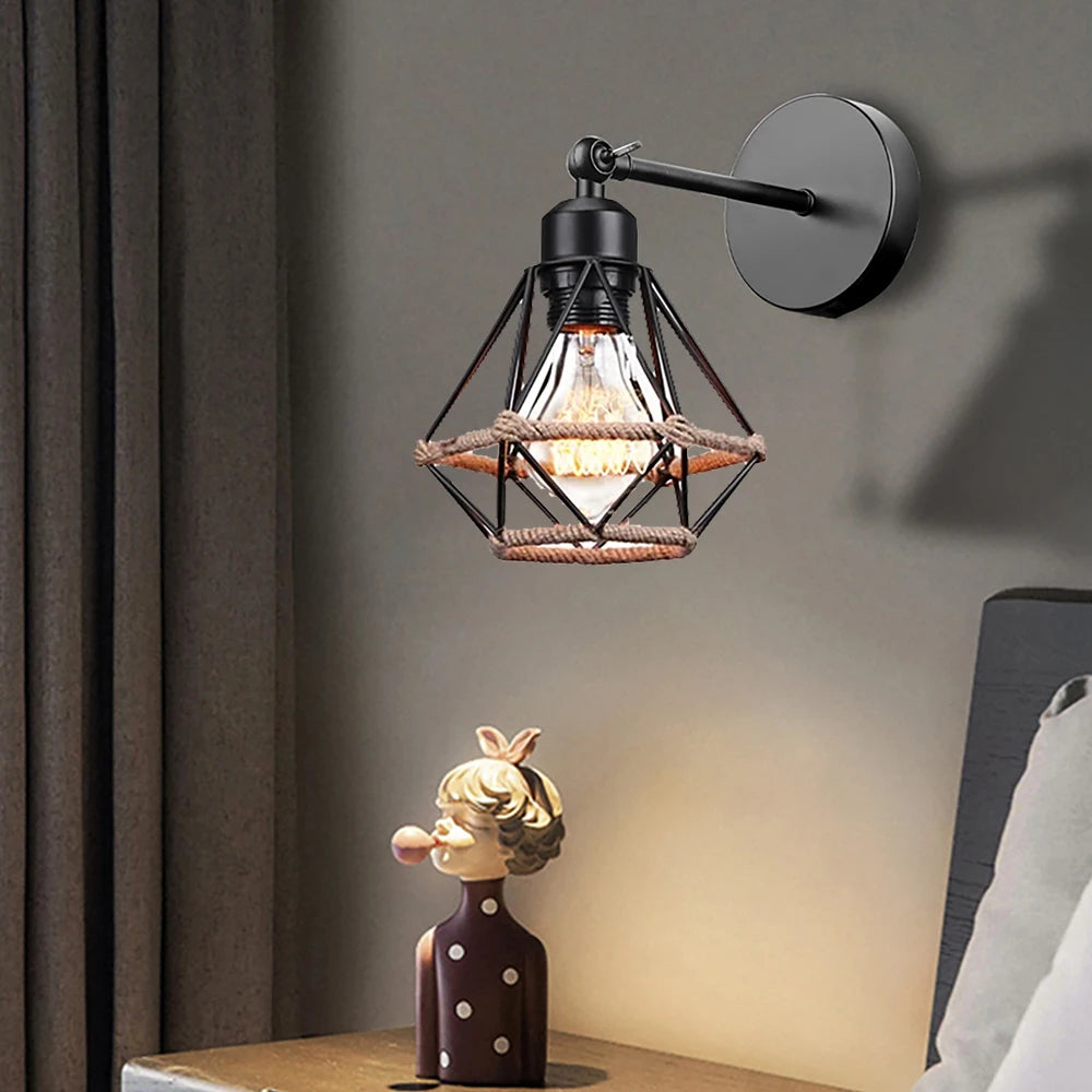 Wall-mounted industrial-style lamp with a decorative figure on a table below.
