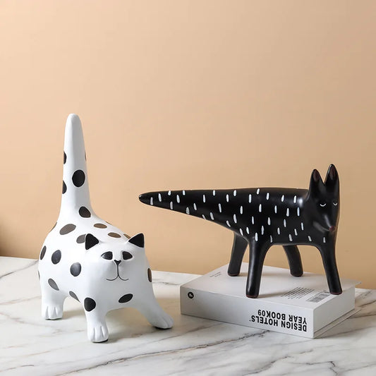 Modern black and white resin cat and fox ornaments styled as minimalist shelf decor for contemporary interiors