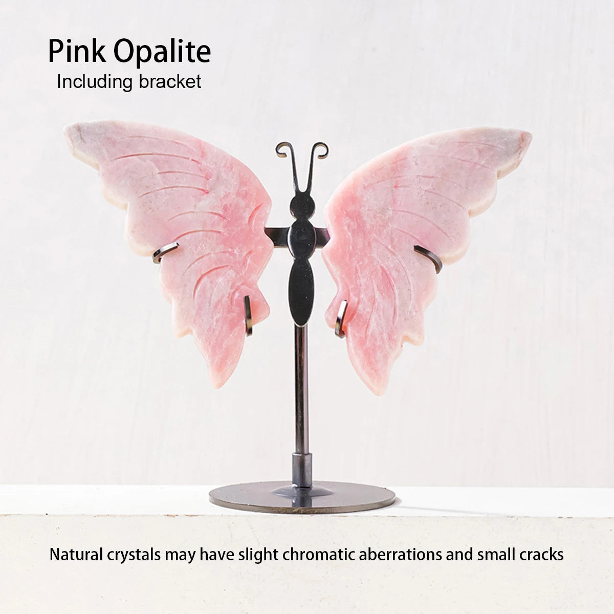 Pink opalite butterfly crystal on a stand with text about natural crystals.