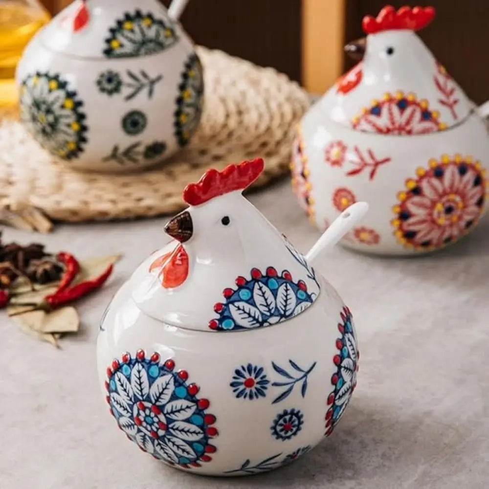 Decorative ceramic chicken-shaped containers with colorful patterns on a neutral background.