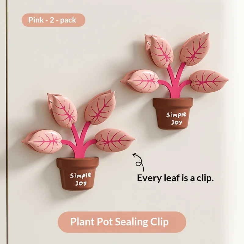 Pink plant pot sealing clips with leaves that are actually clips on a white background.