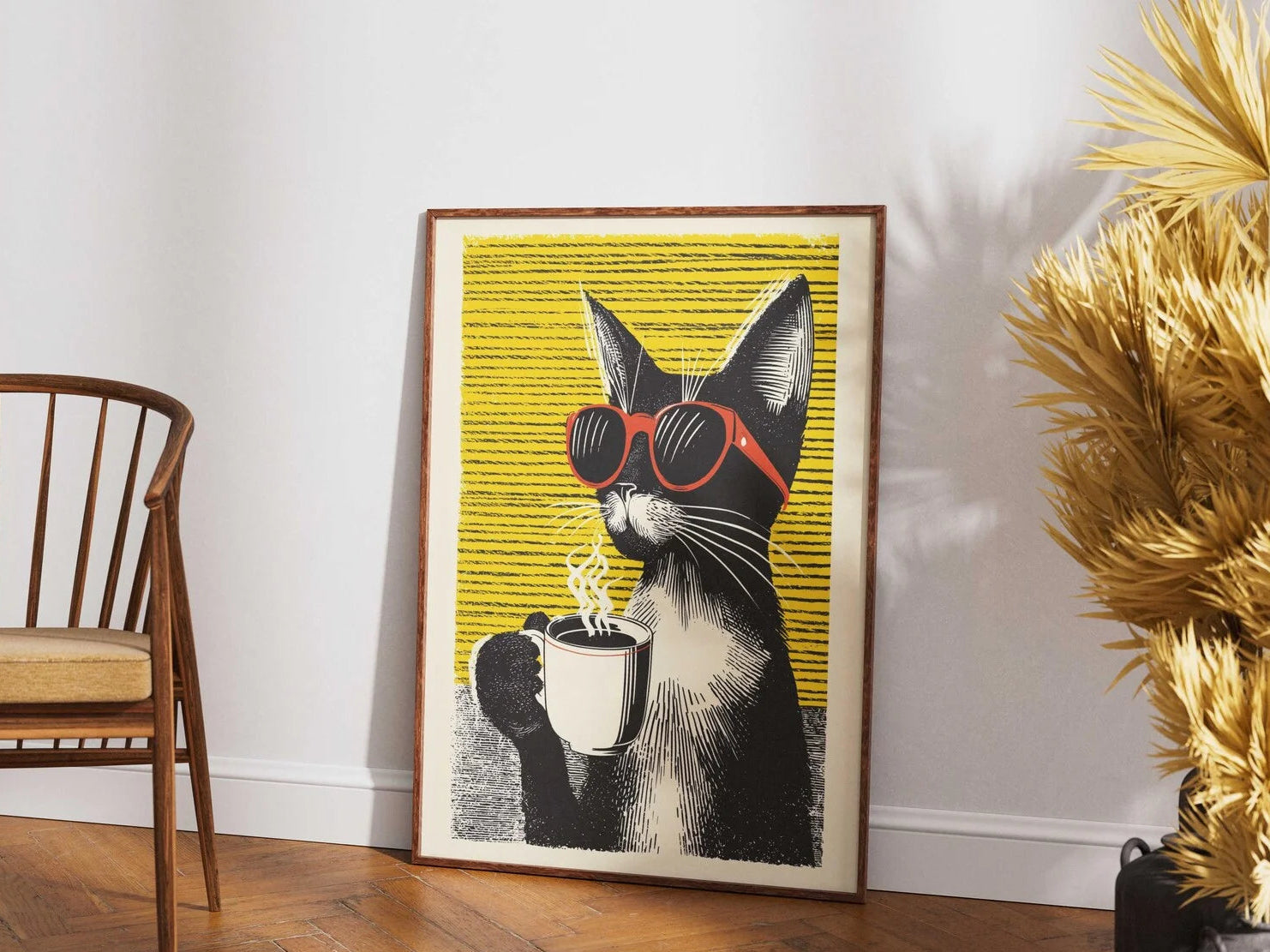 Framed artwork of a cat wearing sunglasses and holding a coffee cup on a wall.