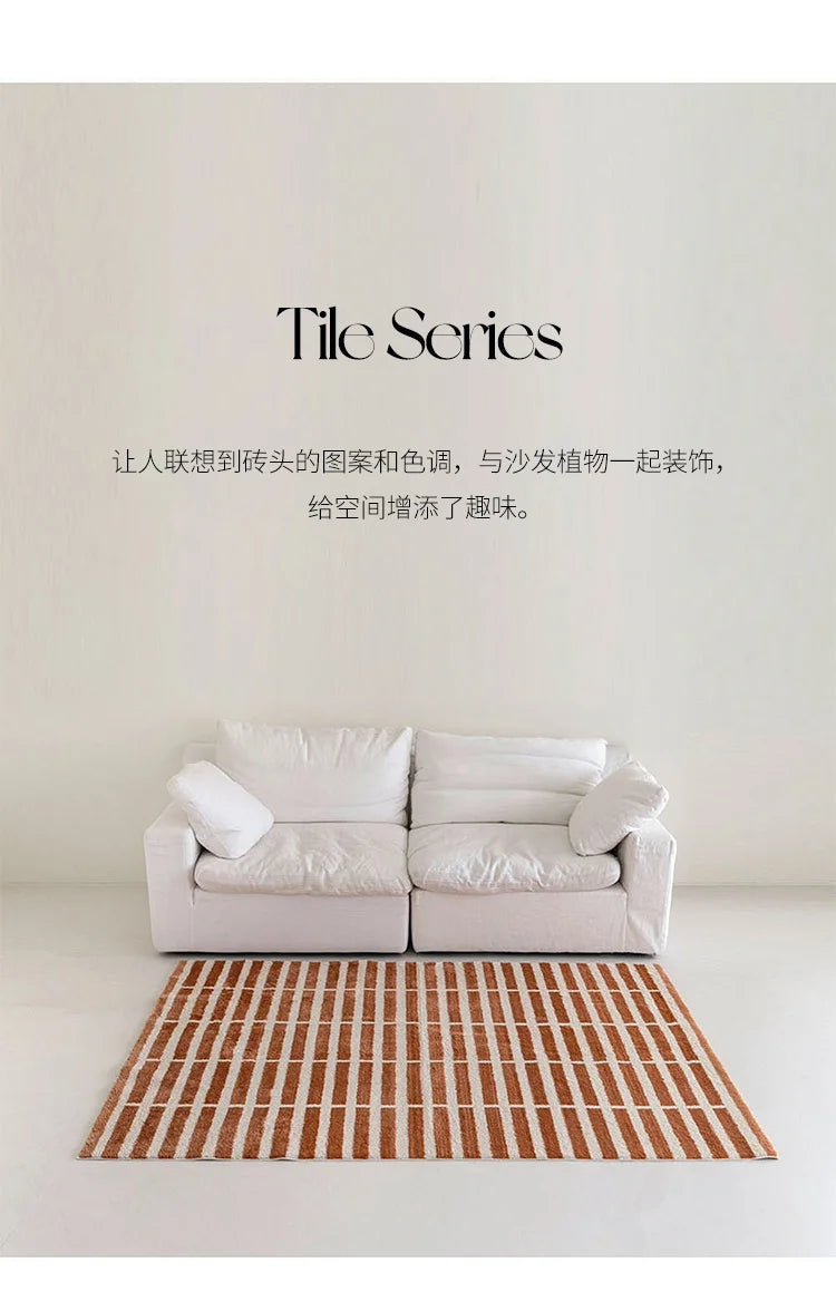 White sofa with a striped rug on a plain background, featuring the 'Tile Series' text.
