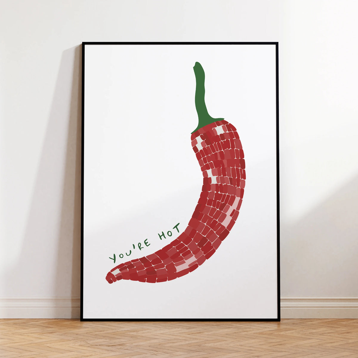 Framed artwork of a red chili pepper with 'You're Hot' text on a white background