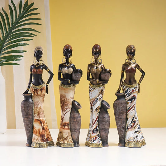 African-inspired decorative resin woman figurines featuring detailed jewellery, patterned dresses and warm earthy finishes.
