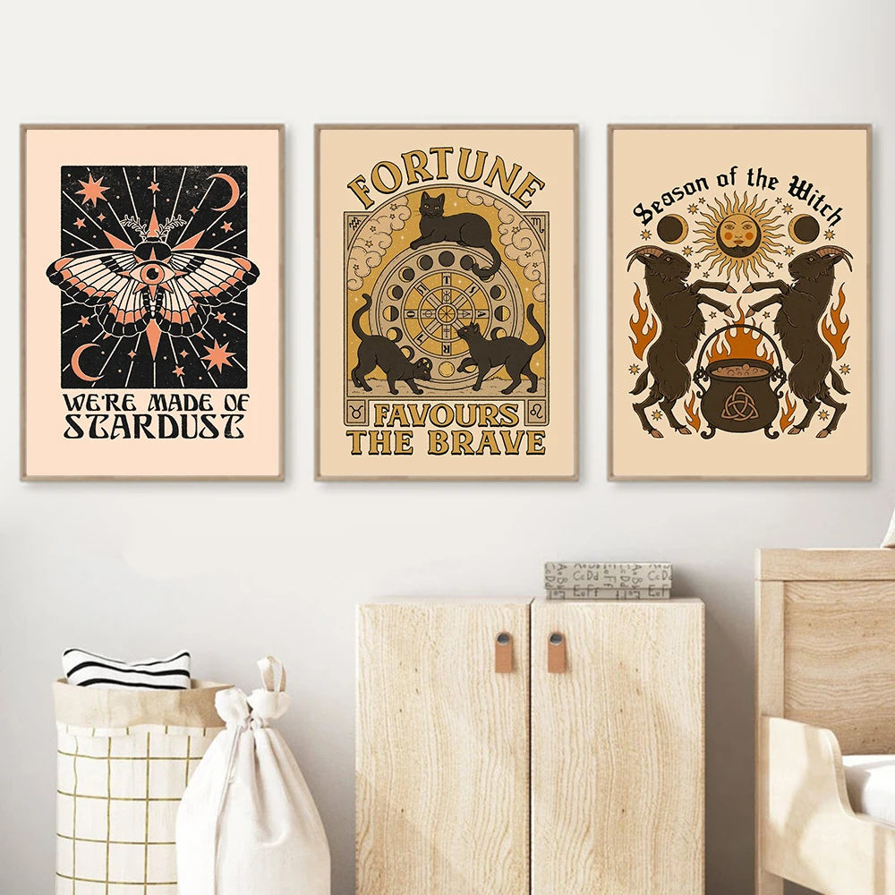 Three framed posters with witchy designs and text on a wall above a wooden cabinet.