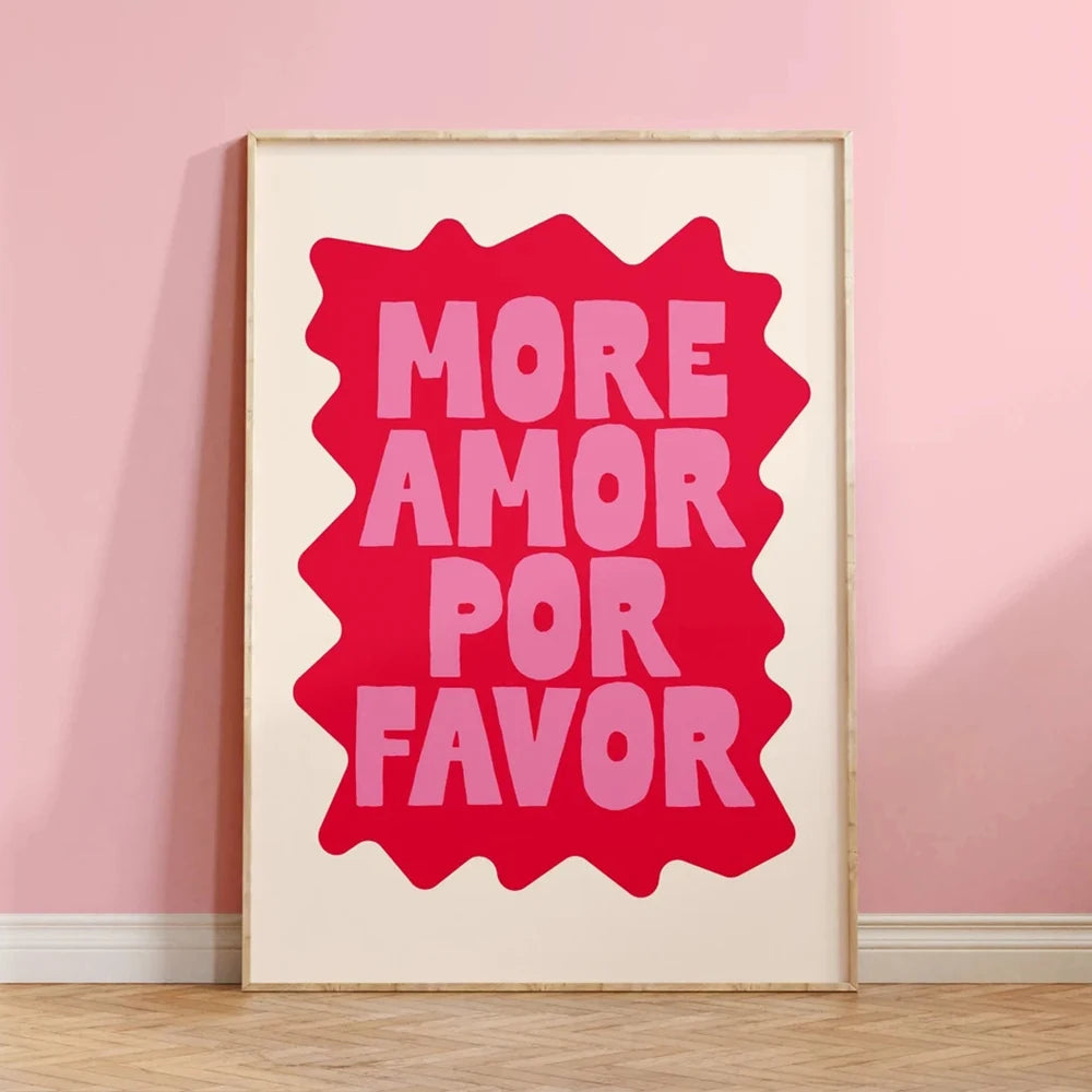 Framed artwork with 'More Amor Por Favor' text on a pink wall.