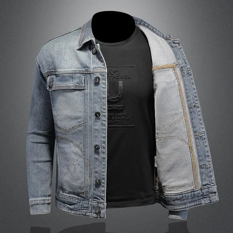 Denim jacket over a black t-shirt with visible branding on a gray background