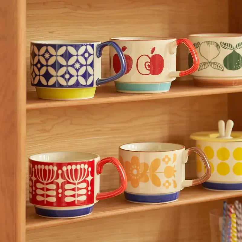 Set of colorful mugs with patterns on a wooden shelf