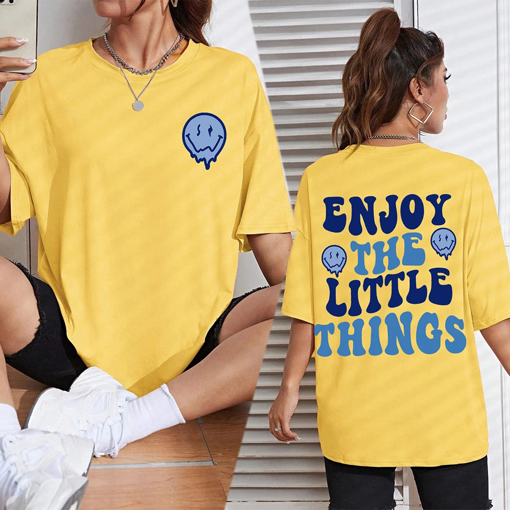Two people wearing yellow t-shirts with a blue smiley face design and text.
