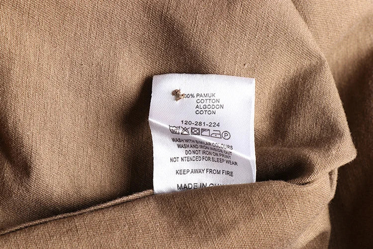 Close-up of a clothing label on a brown fabric background