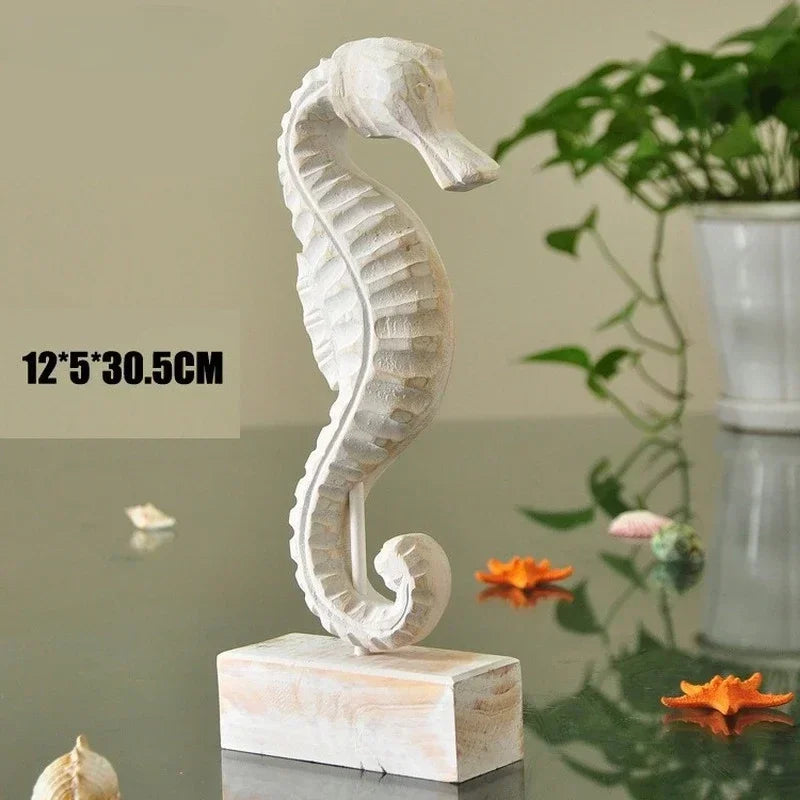 Decorative seahorse sculpture on a reflective surface with a plant in the background