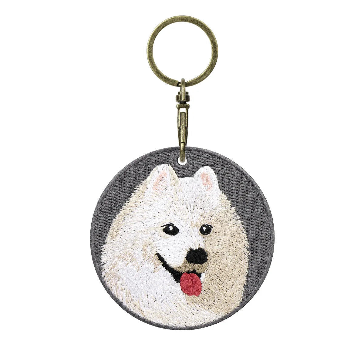 Keychain with embroidered dog face design on a white background