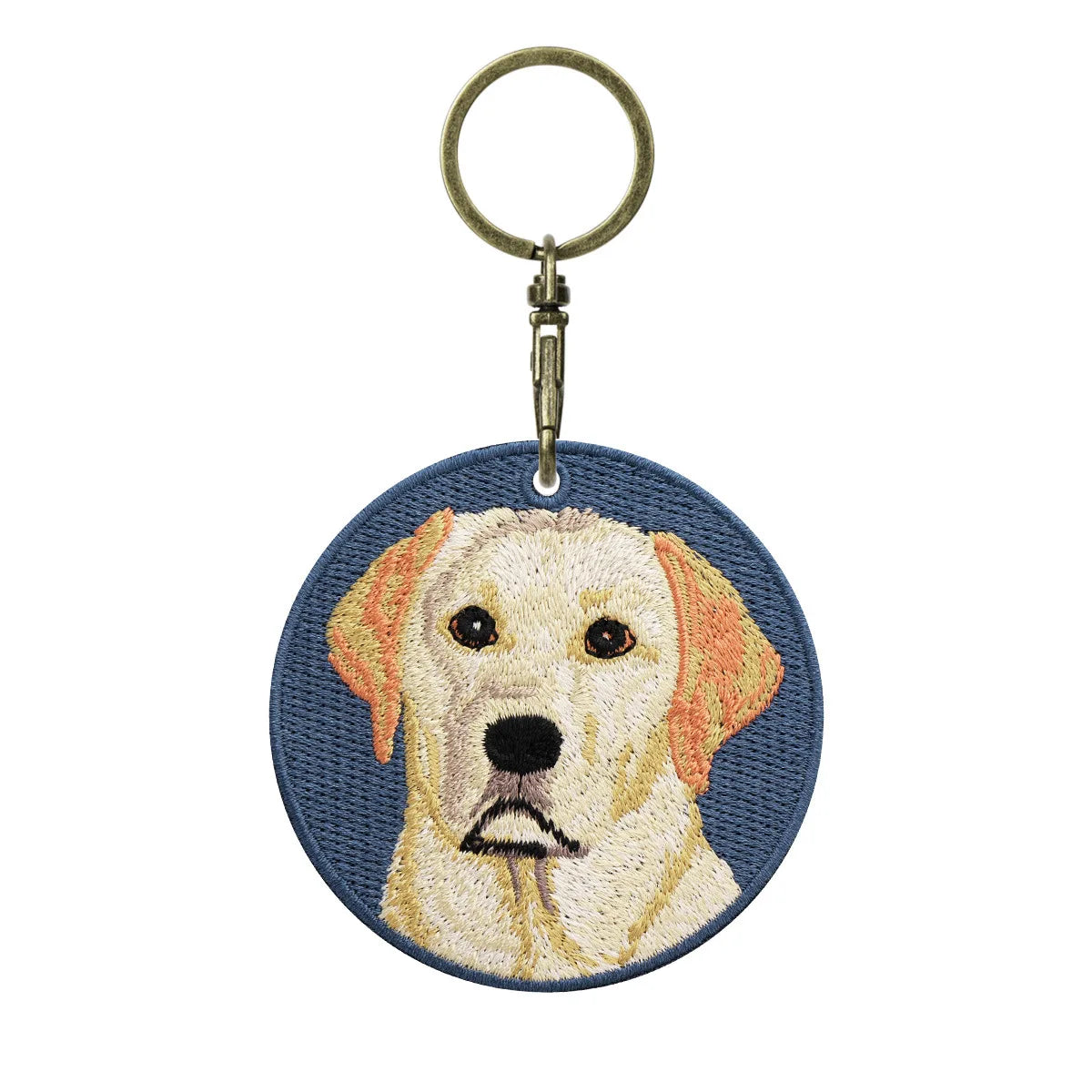 Keychain with embroidered dog face design on a blue background