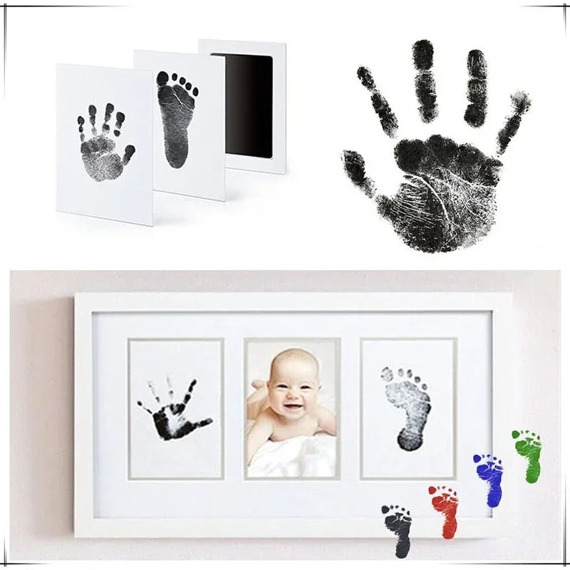 Baby handprint and footprint kit with ink pads and photo frame on a white background