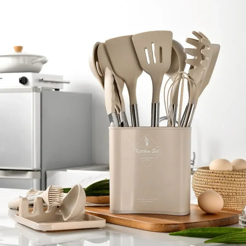 Beige kitchen utensil set in a holder on a kitchen counter with a blurred background