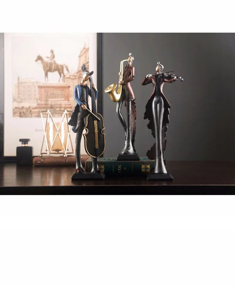 Three musical instrument figurines on a shelf with a painting in the background