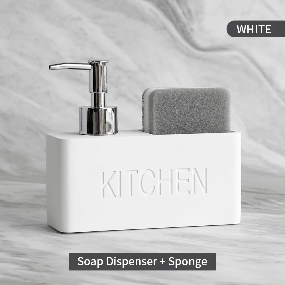 White soap dispenser with silver pump and gray sponge on a marble surface, labeled 'Kitchen'.