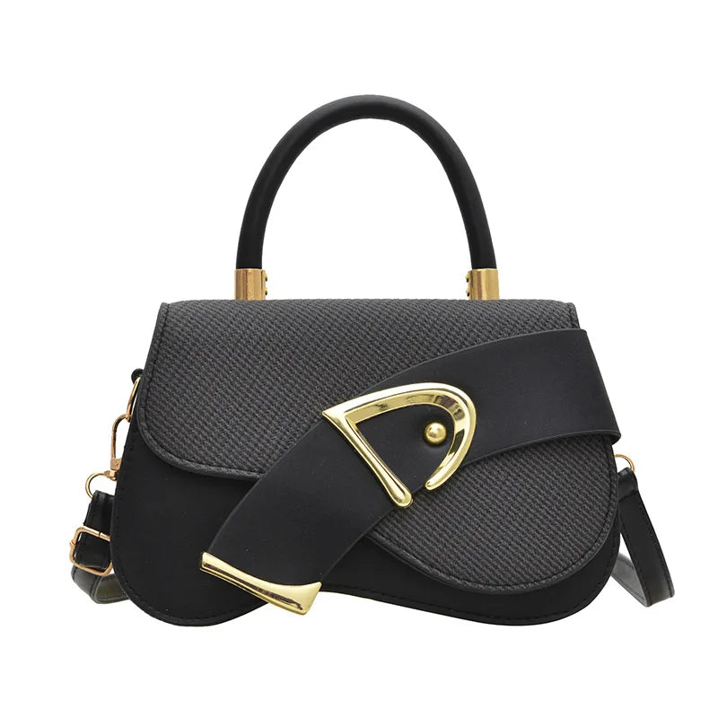 Black handbag with gold accents on a white background