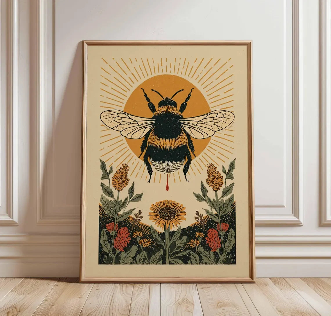 Framed artwork of a bee and flowers on a beige wall.
