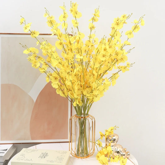 Tall yellow artificial flower bouquet with silk-effect petals displayed in a decorative vase