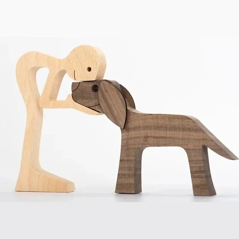 Wooden sculpture of a dog and a person on a white background