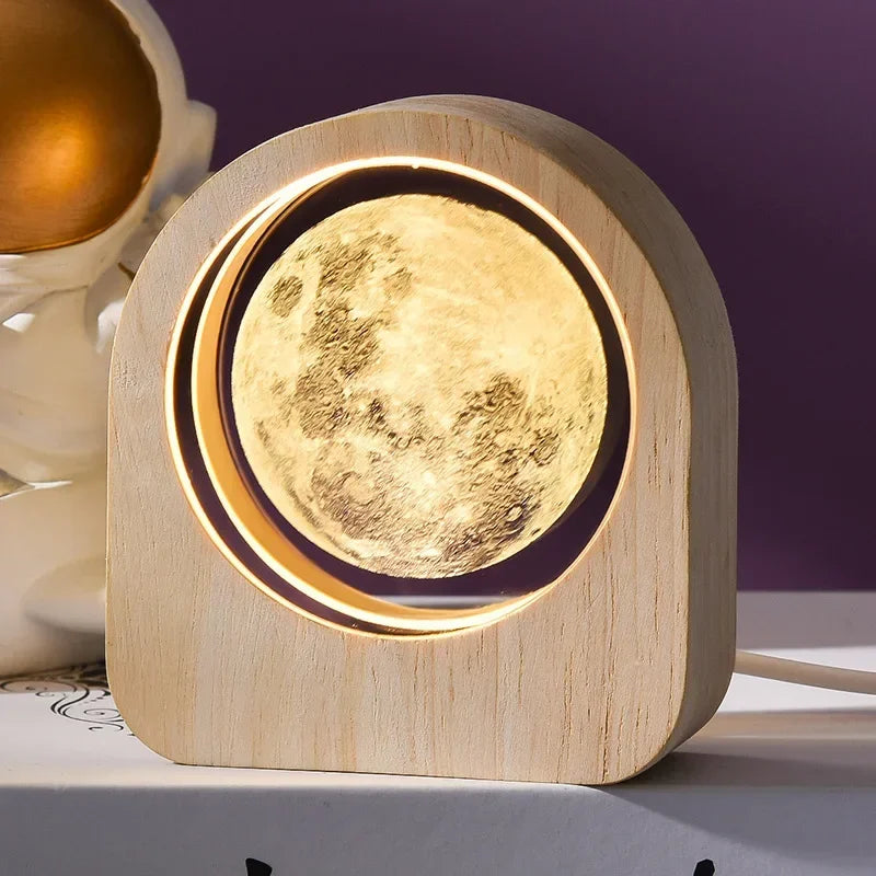 Moon-shaped lamp with wooden base on a table
