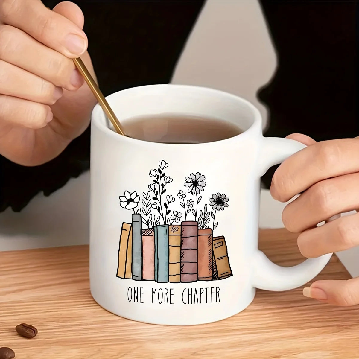 Floral ceramic mug featuring the phrase "Another Chapter" alongside an illustrated book design. A charming 320ml coffee cup for book lovers, readers and cosy reading nook decor