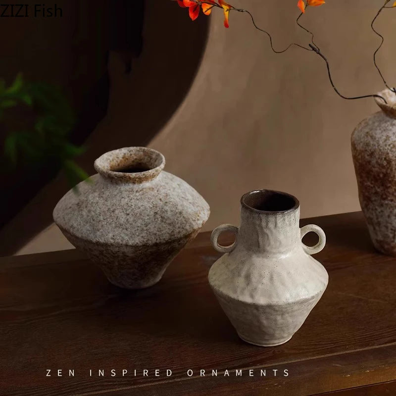 Two Wabi-sabi ceramic vases on a wooden surface with a blurred background