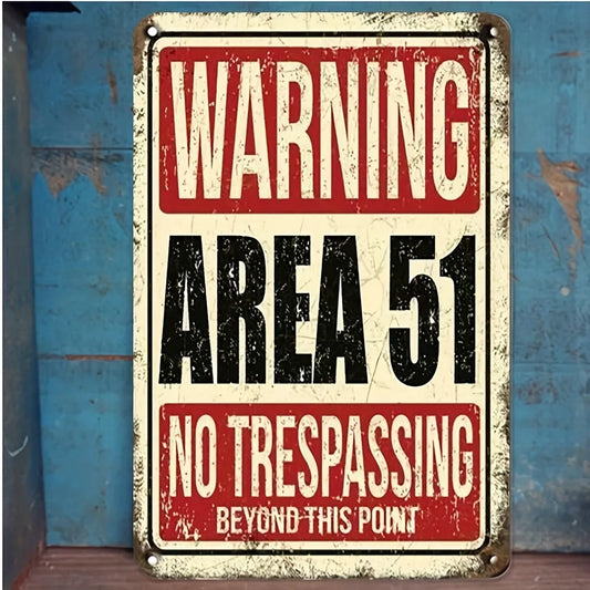 Vintage-style 'Warning Area 51 No Trespassing' sign on a textured surface.