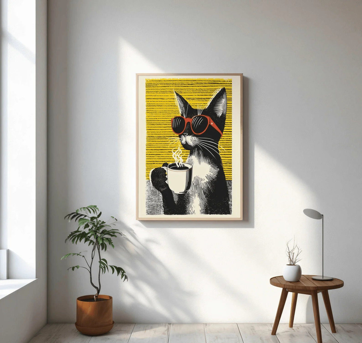 Framed artwork of a cat with sunglasses holding a cup on a wall in a bright room.