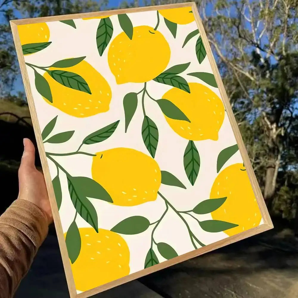 Framed artwork with a pattern of yellow lemons and green leaves held by a person outdoors.