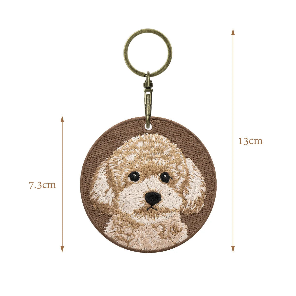 Keychain with embroidered dog design and measurement details on a white background