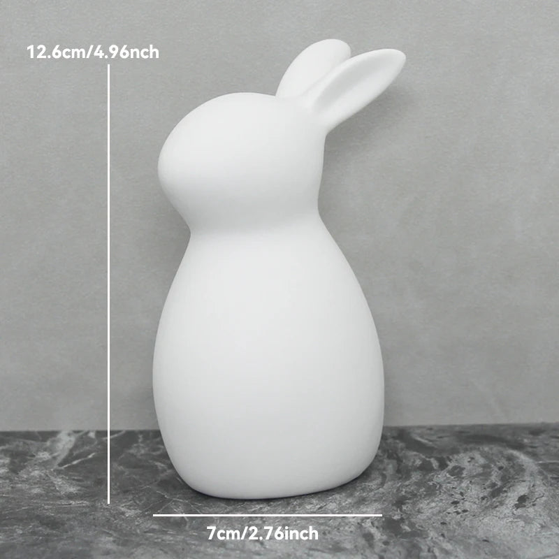 White rabbit-shaped lamp on a gray surface with measurements indicated.