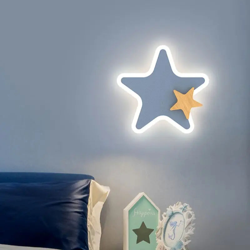 Star-shaped light fixture on a wall with decorative elements below.