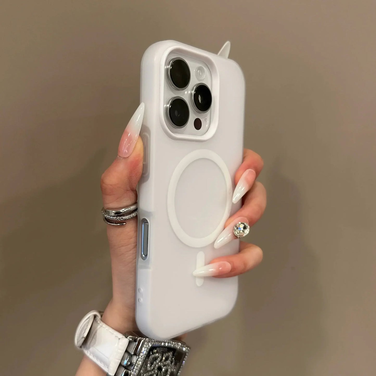 Hand holding a white phone case with a plain background