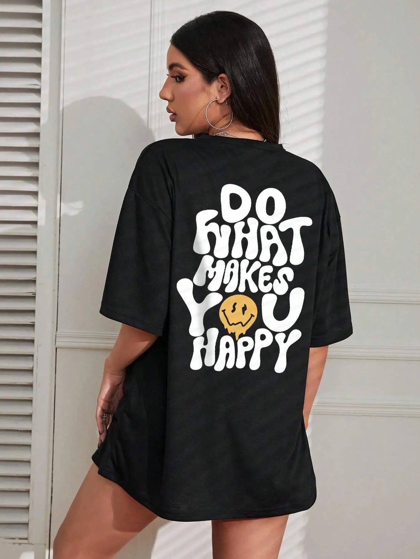 Person wearing a black t-shirt with a motivational quote on the back.