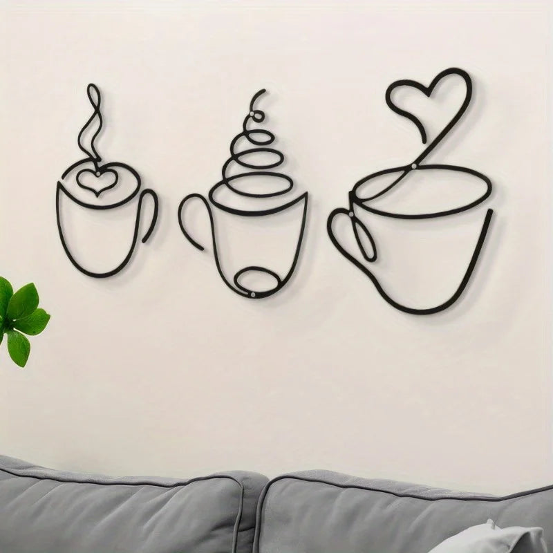 Decorative wall art of coffee cups and a heart on a plain wall.
