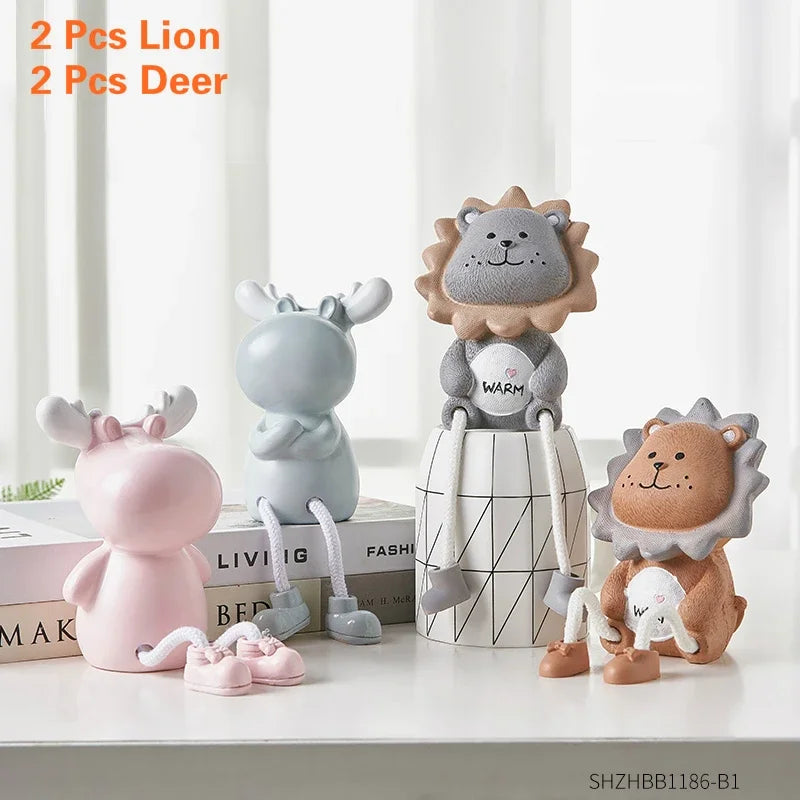 Four small animal figurines on a white surface with a neutral background