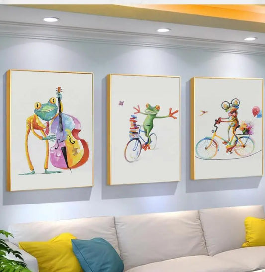 Three colorful frog paintings on a wall above a sofa.