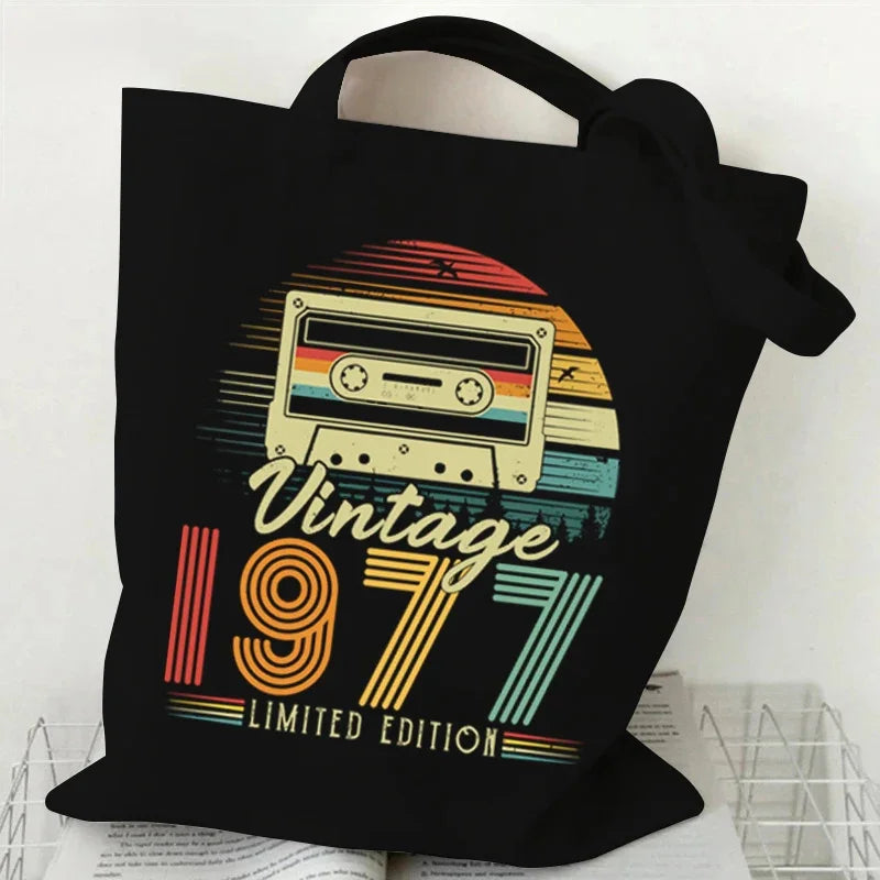 Black tote bag with a retro cassette design and 'Vintage 1977 Limited Edition' text on a white background.