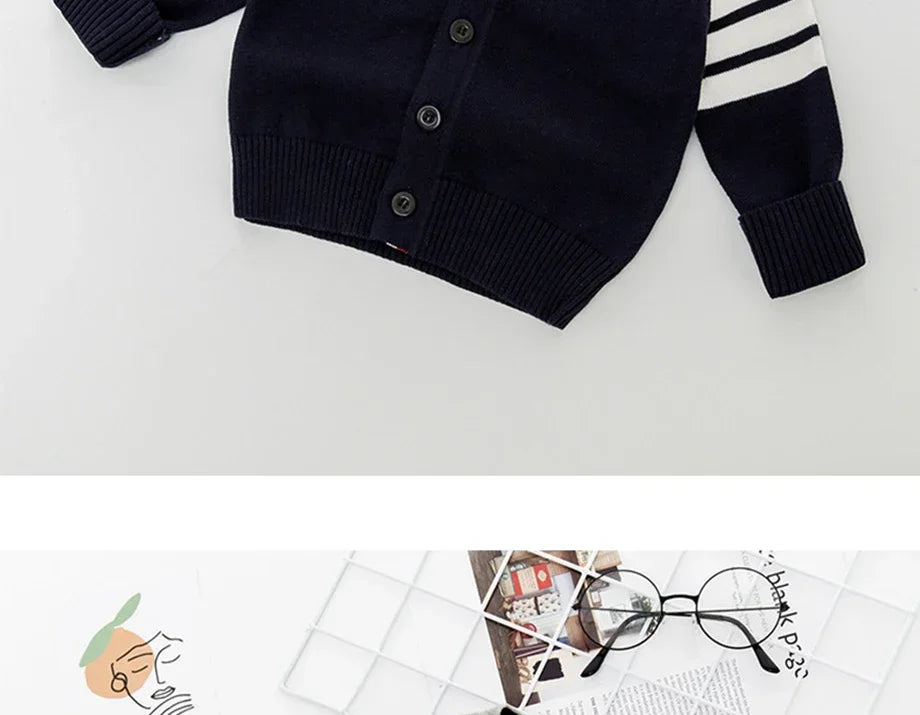 Navy cardigan with white stripes on sleeves on a light gray background